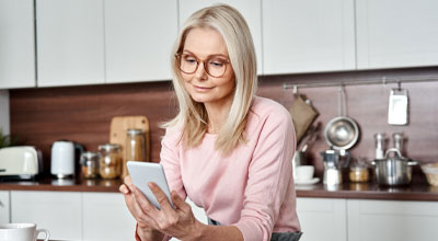 middle aged 50 years old woman browsing online